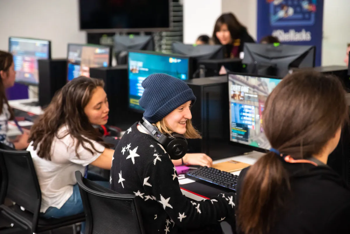 Girls playing games at a row of computers