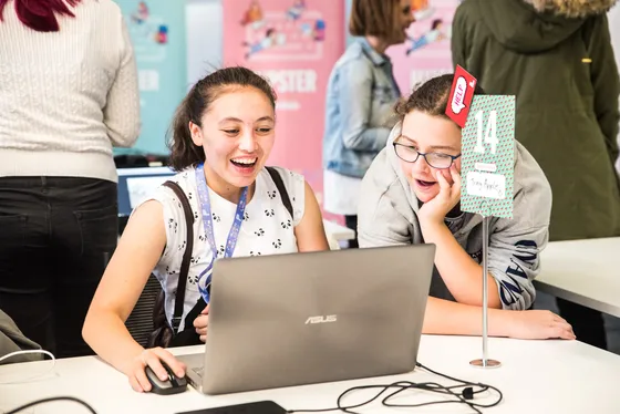 High school girls laughing at a laptop