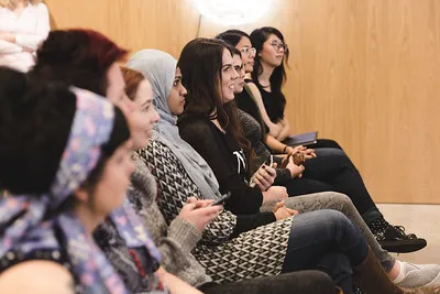 An audience listening at a conference session