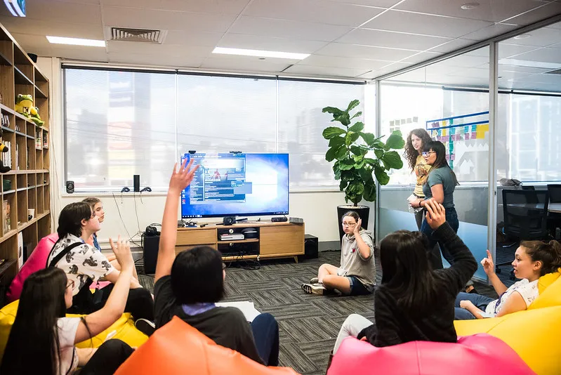 Participants watching a screen from beanbags