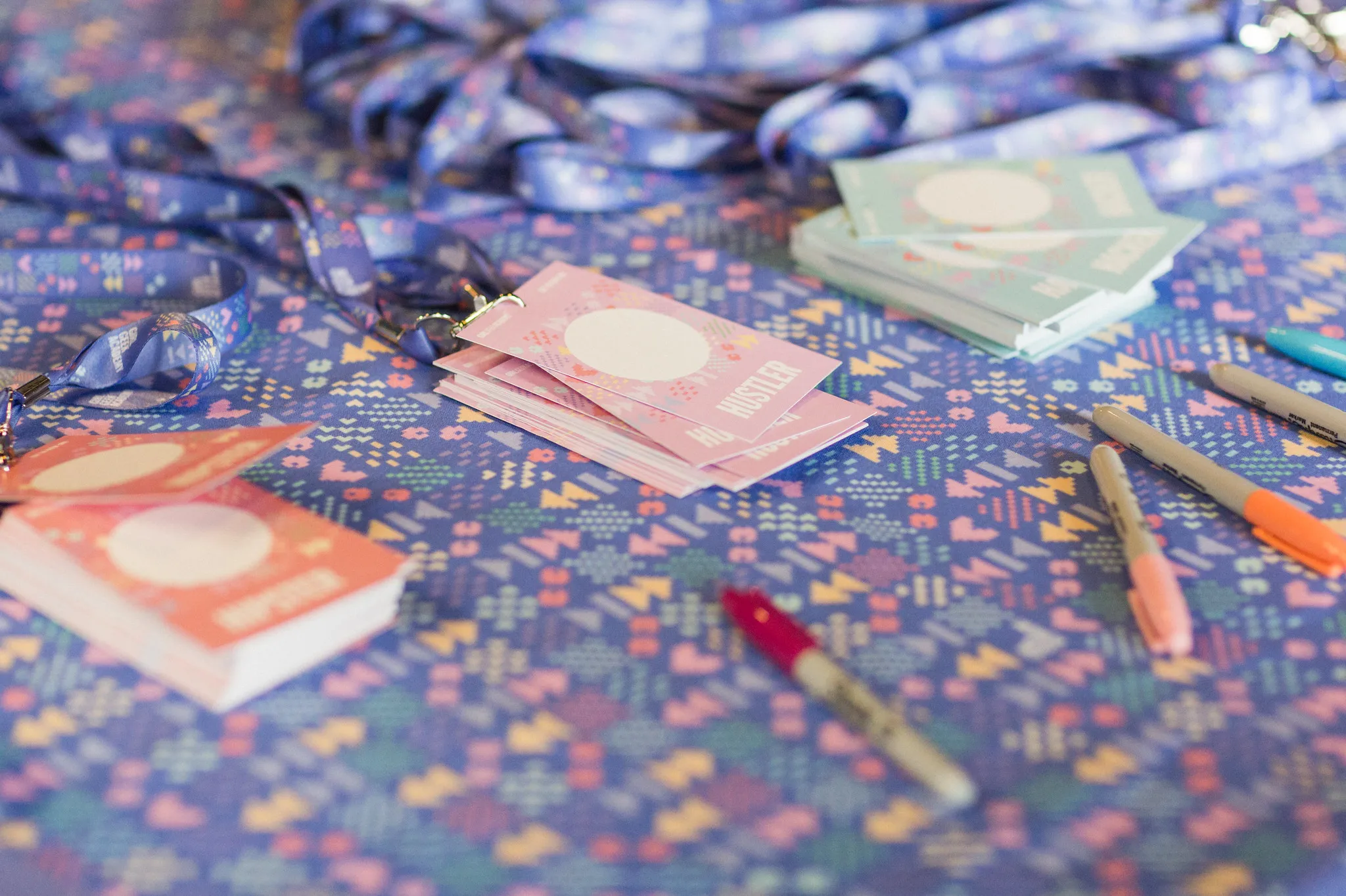 Lanyards, badges and stickers laid out on a table