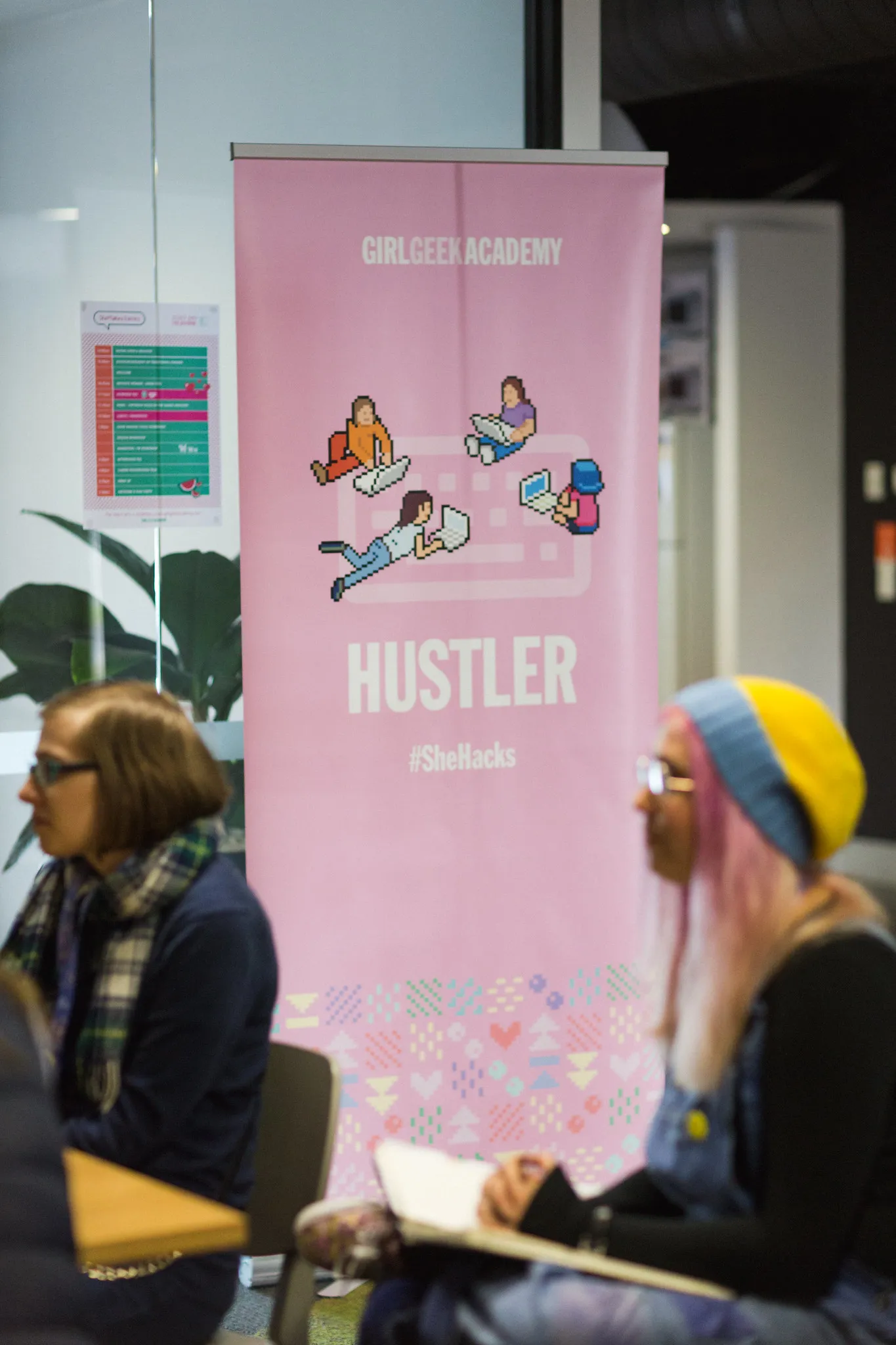 Participants beside the Hustler banner