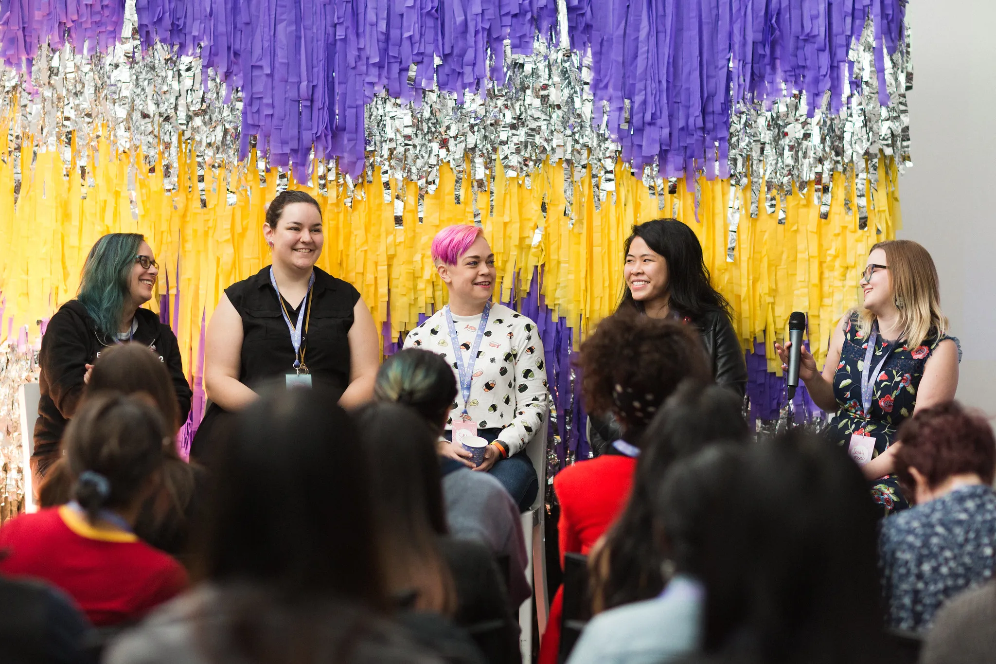 A panel in front of a tinsel backdrop