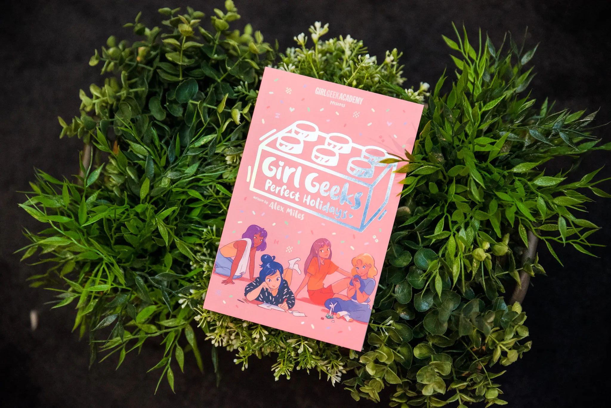 A Girl Geeks book on a bed of leaves