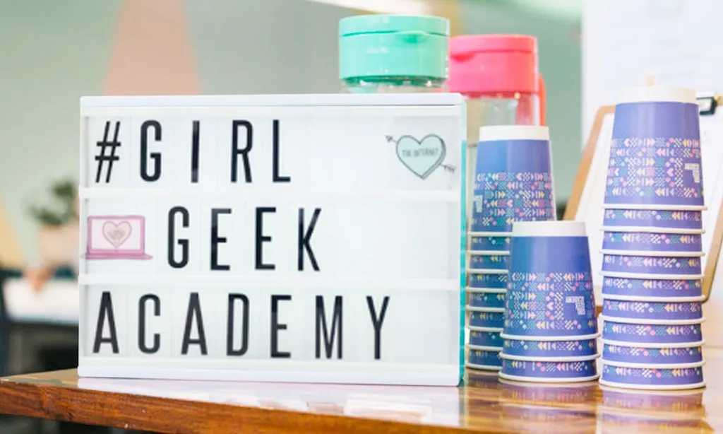 A #GirlGeekAcademy letter board with coffee cups