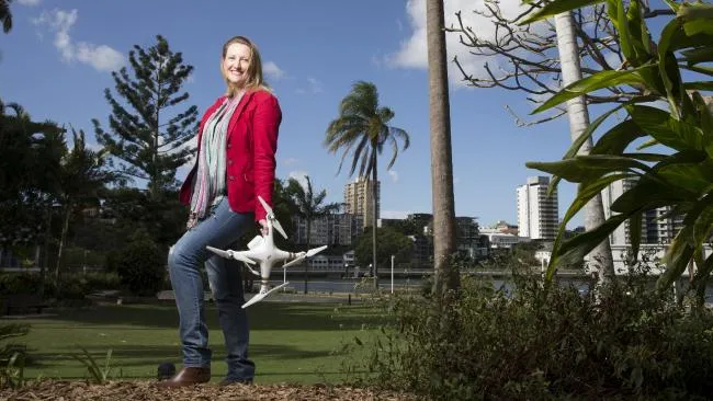 A woman flying a drone outdoors