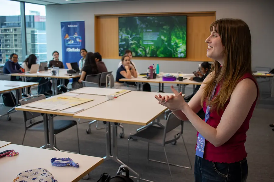 A speaker talking to students around the room